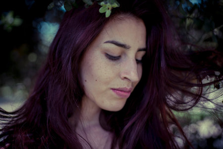 melancholic girl in a forest in autumn, red long hair