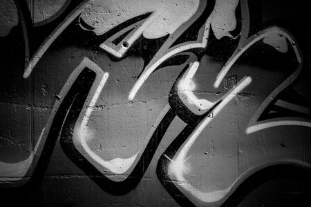 black ink grafitti design in city wall, street art segment