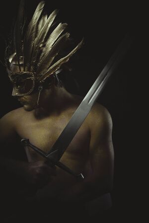 vintage warrior helmet and gold feathers, giant iron swordの写真素材