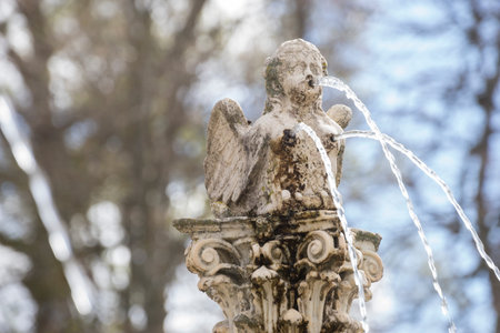 fountain shaped figure angel water jets coming out of breasts and mouth, spring in Spainの写真素材