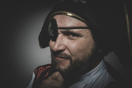 Sexy man pirate with eye patch and old hat with funny faces and expressiveの写真素材