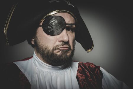 Angry man pirate with eye patch and old hat with funny faces and expressiveの写真素材