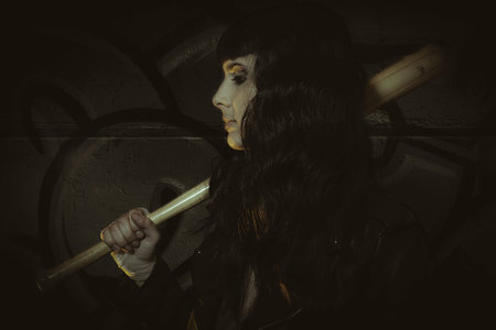 Effort, brunette sensual and sexy with weapons in aggressive and dangerous positionの写真素材