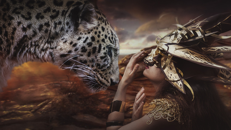 Savage, brunette goddess dressed in gold lace dress. concept deity and faithの写真素材