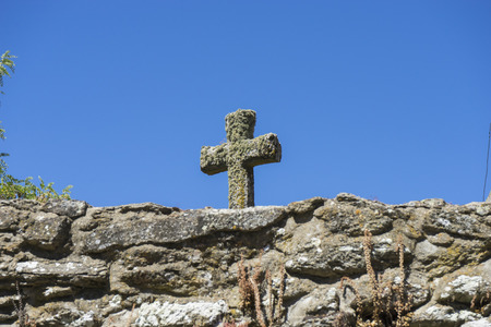 stone cross on the wall of a church, ancient architecture inside Zamora, Spain, stone housesの写真素材