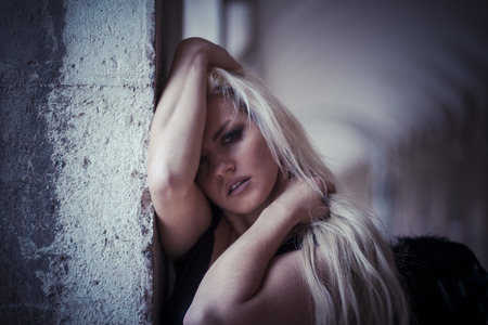 Love, an angel in the city, beautiful blonde with long hair dressed in black and with black wingsの写真素材