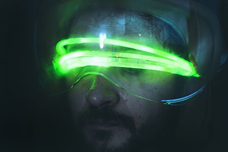 man of the future with helmet and goggles green LED wiresの写真素材