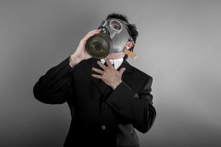 Pollution, Businessman with gas mask, concept business dangerous for the environment or for societyの写真素材