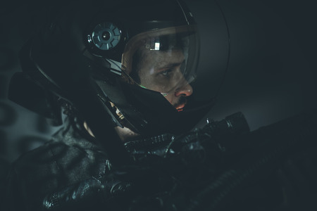 Space man with metal helmet and laser beam weaponの写真素材