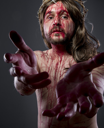 Hands, Jesus christ, jesus of nazareth with the crown of thorns and blood for his body as penance before the crucifixionの写真素材