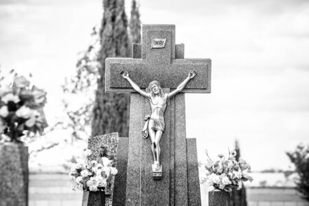 Cemetery, details of crosses and tombs with sculptures of jesus christ and angels in spainの写真素材
