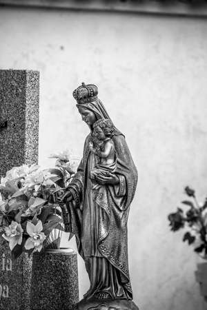 Cemetery, details of crosses and tombs with sculptures of jesus christ and angels in spainの写真素材