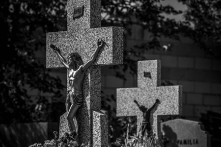 Death, Cemetery, details of crosses and tombs with sculptures of jesus christ and angels in spainの写真素材