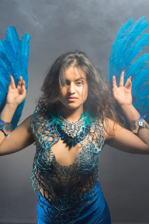 Glamour, Brunette woman in costume made of blue feathers, wild and free bird, fantasy imageの写真素材