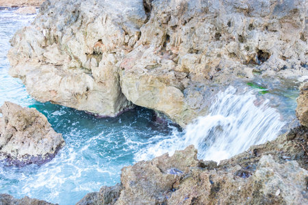 Rocks by the sea with waves of the Mediterranean sea next to the Cabo de Formentor in the Balearic Islands, Spain. Scenes of Spanish tourismの写真素材