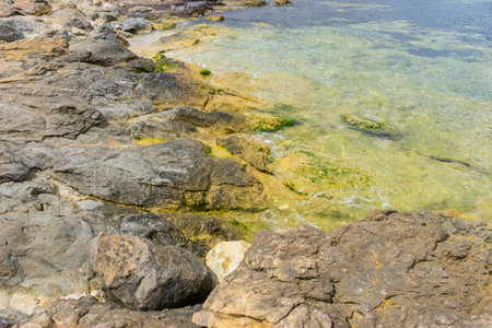 Rocks by the sea with waves of the Mediterranean sea next to the Cabo de Formentor in the Balearic...