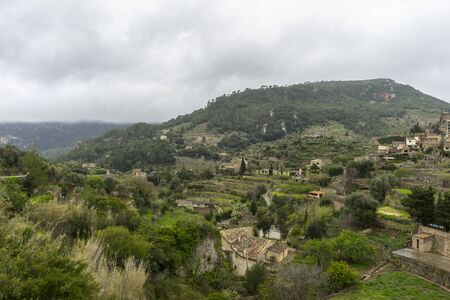 rustic, flowerpots street in the tourist island of Mallorca, Valdemosa city in Spainの写真素材
