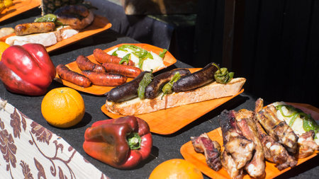 Barbecue scene with peppers and pork at a medieval fair in spain, typical spanish foodの写真素材