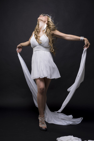 Luxury, Beautiful greek blonde woman, mythology, dressed in white silk dress and laurel wreath handmade with silverの写真素材