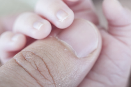 Hand of newborn. Hands of father and son united. Maternity and paternityの写真素材