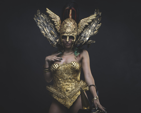 Twilight, Latin woman with green hair and gold tiara, wears a handmade warrior armorの写真素材