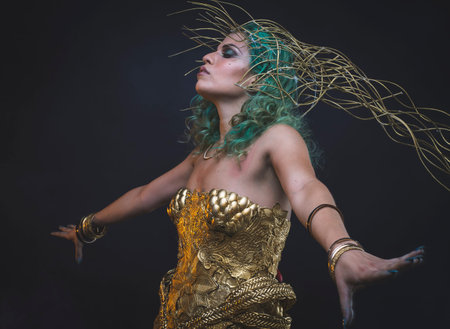 Relaxation Latin woman with green hair and gold costume with handmade flourishes, fantasy image and taleの写真素材