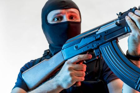 Thief, man armed with balaclava and bulletproof vest, gun and shotgun, kalashnikovの写真素材