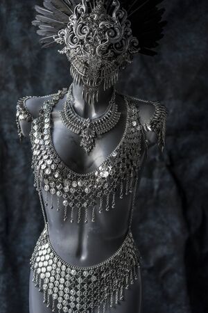 handmade piece, silver jewelry costume with chains and coins. wears a headdress made with feathers and gothic piecesの写真素材