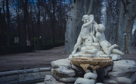 Gardens of the city of Aranjuez, located in Spain. Stone palace and beautiful autumn landscapes with beautiful fountains and mythological figuresの写真素材