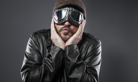 retro, old airplane pilot with brown leather jacket, arador hat and large glassesの写真素材