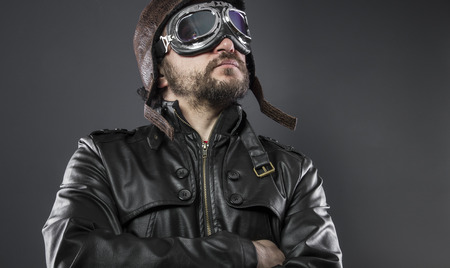 old airplane pilot with brown leather jacket, arador hat and large glassesの写真素材