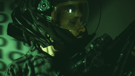 Soldier, cyborg man of the future with helmet lights led and huge laser gunの写真素材