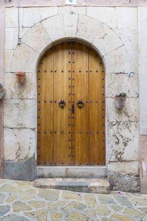 old wooden door in a coastal village of the island of Mallorca in Spain, next to the mediterranean sea, vacation and rest conceptの写真素材