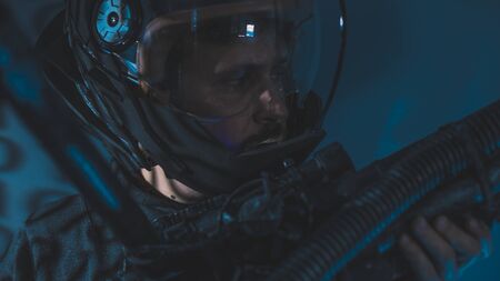 Mission, space man with led lights helmet, space suit and gun in the shape of a cannonの写真素材