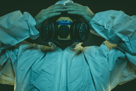 virus infection concept. Man in protective suit and antigas mask with glasses. Ebola, toxic gases, biological warfare, infections and diseasesの写真素材