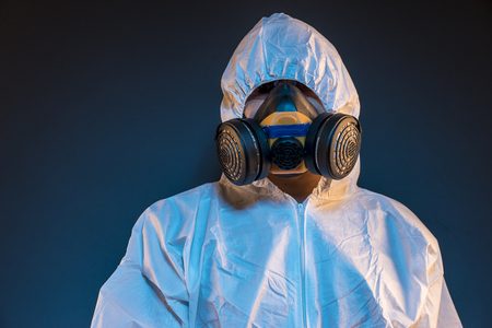 virus infection concept. Man in protective suit and antigas mask with glasses. Ebola, toxic gases, biological warfare, infections and diseasesの写真素材