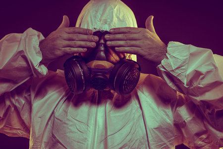 Hazmat Contagious virus infection concept. Man in protective suit and antigas mask with glasses. Ebola, toxic gases, biological warfare, infections and diseasesの写真素材