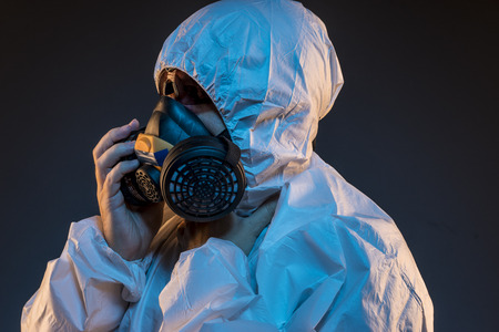 virus infection concept. Man in protective suit and antigas mask with glasses. Ebola, toxic gases, biological warfare, infections and diseasesの写真素材