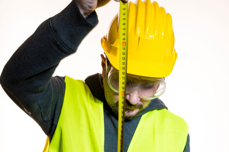 a man who wants to do a work without knowledge, work without experience. Do it yourself, man dressed in yellow builder helmet with protective glasses ready to start the construction workの写真素材