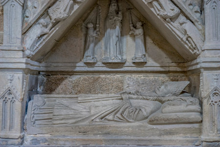 burial in stone of a Christian bishop in the interior of a religious cathedral in Spainの写真素材