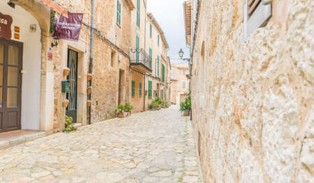 Beautiful street in Valldemossa with traditional flower decoration, famous old mediterranean village of Majorca. Balearic island Mallorca, Spainの写真素材