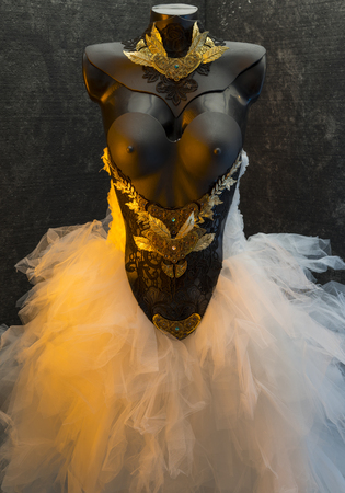 Marriage gothic wedding dress. takes pieces in gold and precious metal lace on black corset. handmade piece with thermoplastic materials and metalsのeditorial素材