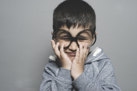 thinking, boy with big glasses very serious and thinkingの写真素材