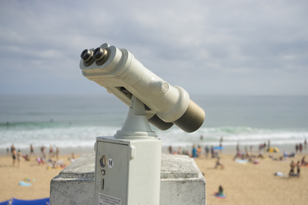 Coin operated binocular on the summer beach, tourist scene in Spainの写真素材