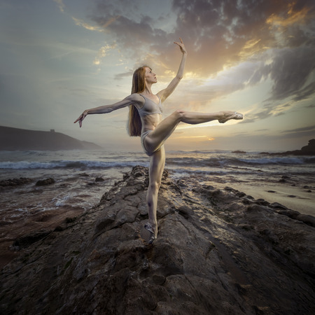 Ballet dancer in a sunset on the beach. concept freedom and nature in its purest stateの写真素材