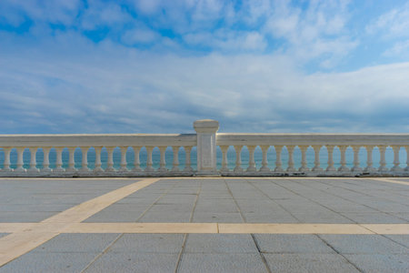 seafront promenade at Playa del Sardinero, view of the beach with a stone railing and the sea in the...