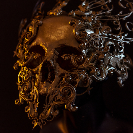 golden skull made with 3d printer and pieces by hand. Gothic piece of decoration for halloween or horror scenesの写真素材