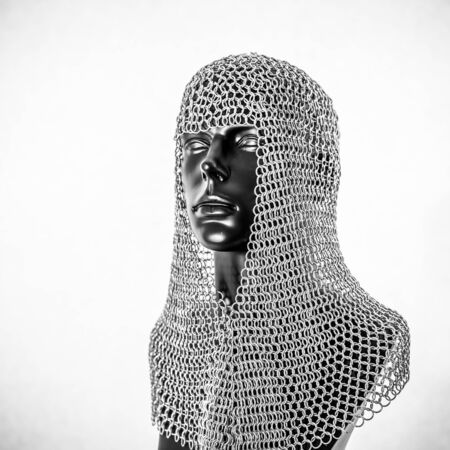 Metal, Viking helmet with chain mail in a black mannequin on white background. clothes for the viking warの写真素材