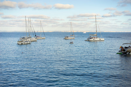 As evening descends, boats in a Mallorca cove paint a picturesque scene, symbolizing the island's...