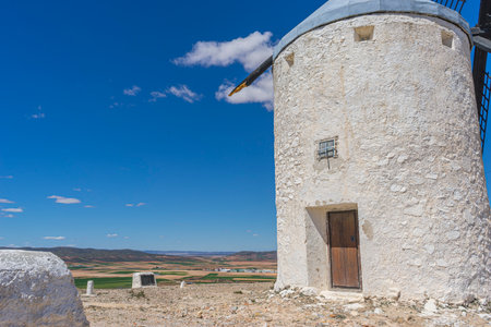 Hilltop windmills, silhouette against the Spanish sky. Toledo's history, culture, and scenic beauty intertwined in one frameの写真素材